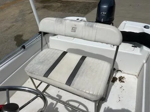 Slide: The Image of 2012 Carolina Skiff JVX18CC boat seat with steering wheel and motor in background. - 7