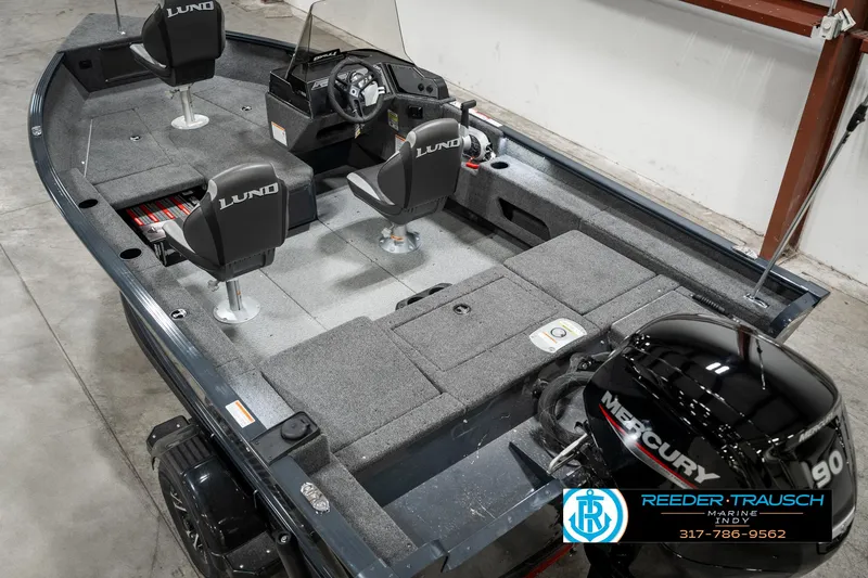 Slide: The Image of 2025 Lund 1675 Adventure SS boat interior with Mercury engine, gray seating, and steering console. - 10