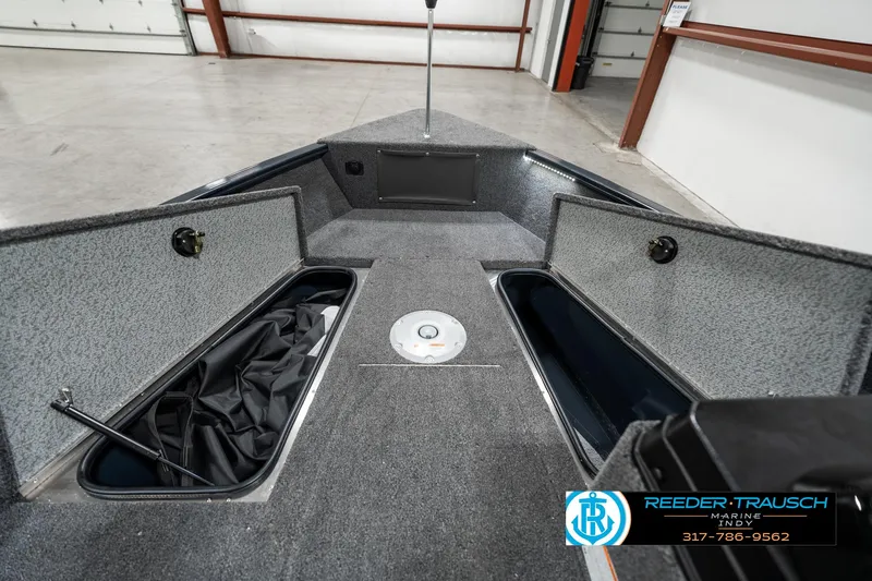 Slide: The Image of 2025 Lund 1675 Adventure SS boat interior with storage compartments in a showroom. - 17