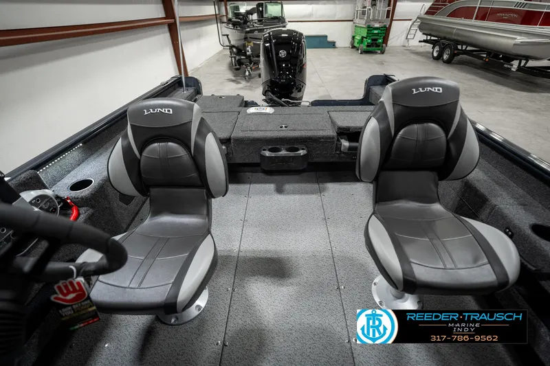 Slide: The Image of 2025 Lund 1675 Adventure SS boat interior with two seats in a showroom. - 19