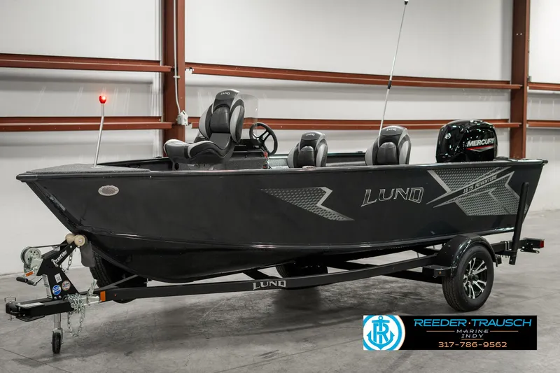 Slide: The Image of 2025 Lund 1675 Adventure SS boat in showroom, featuring sleek design and Mercury engine. - 2