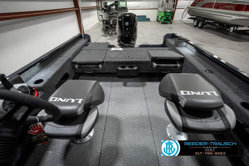 Slide: The Image of 2025 Lund 1675 Adventure SS boat interior with two seats in a showroom. - 20