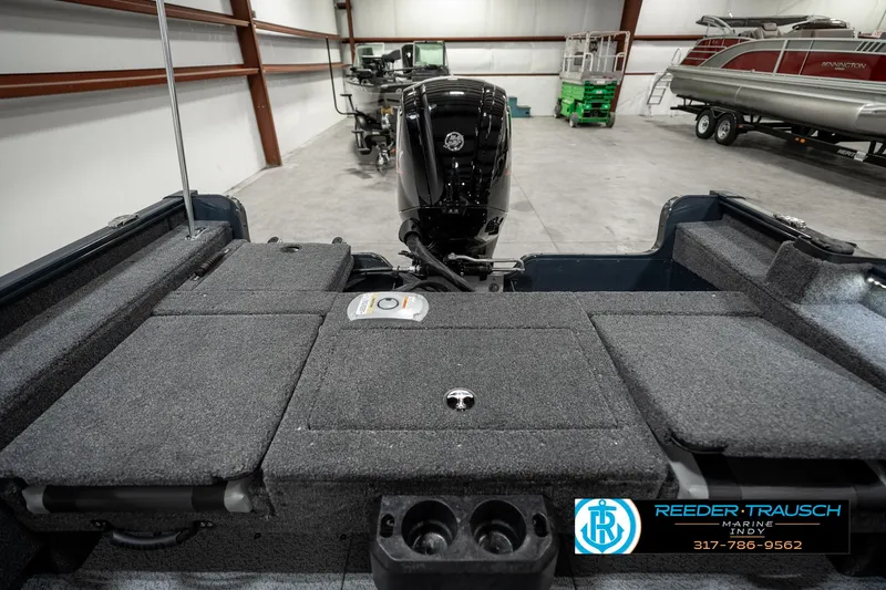 Slide: The Image of 2025 Lund 1675 Adventure SS boat interior with motor, displayed in a showroom. - 21