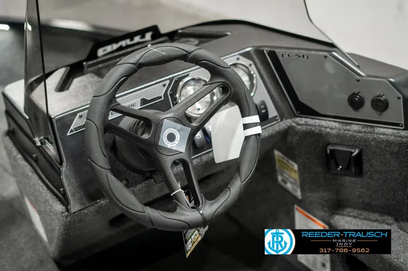 Slide: The Image of 2025 Lund 1675 Adventure SS boat dashboard with steering wheel and control panel. - 27