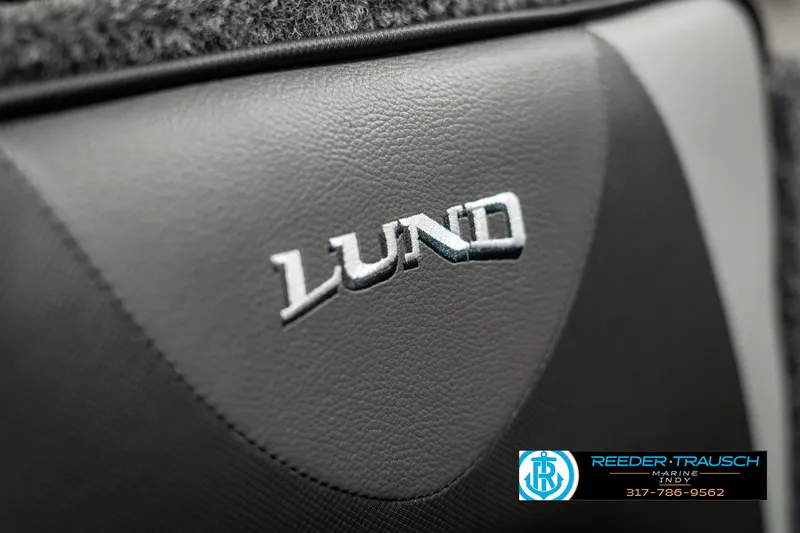 Slide: The Image of 2025 Lund 1675 Adventure SS logo on black leather surface. - 32