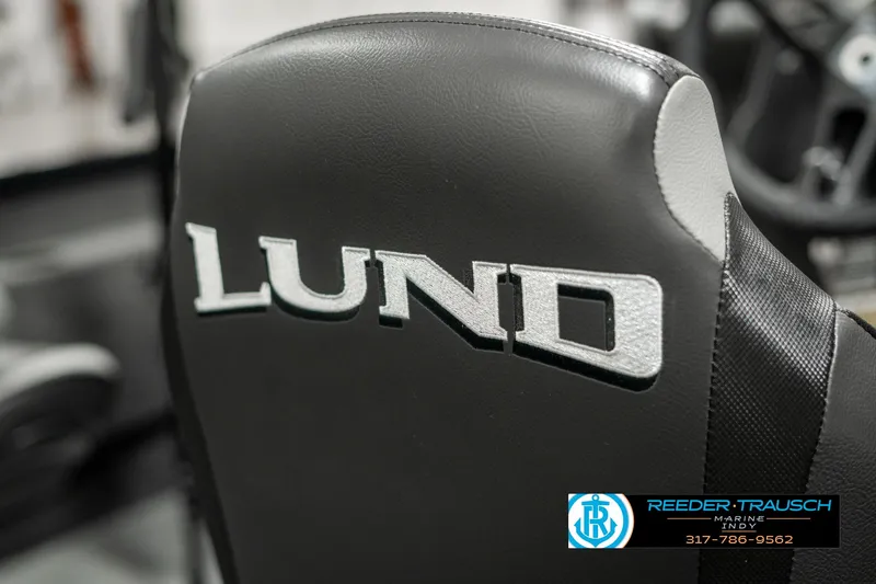 Slide: The Image of 2025 Lund 1675 Adventure SS boat seat with logo, featuring sleek black design. - 33