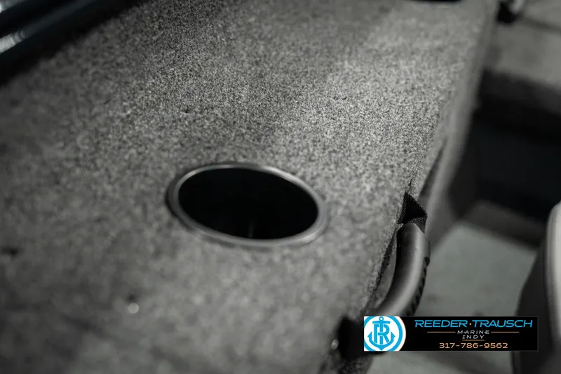 Slide: The Image of 2025 Lund 1675 Adventure SS boat interior with cup holder and carpeted surface. - 34