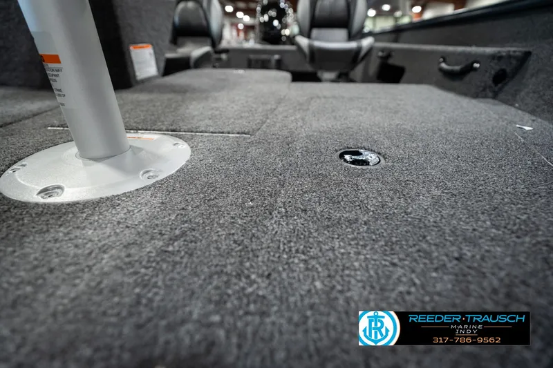 Slide: The Image of 2025 Lund 1675 Adventure SS boat interior with carpeted flooring and seating. - 35