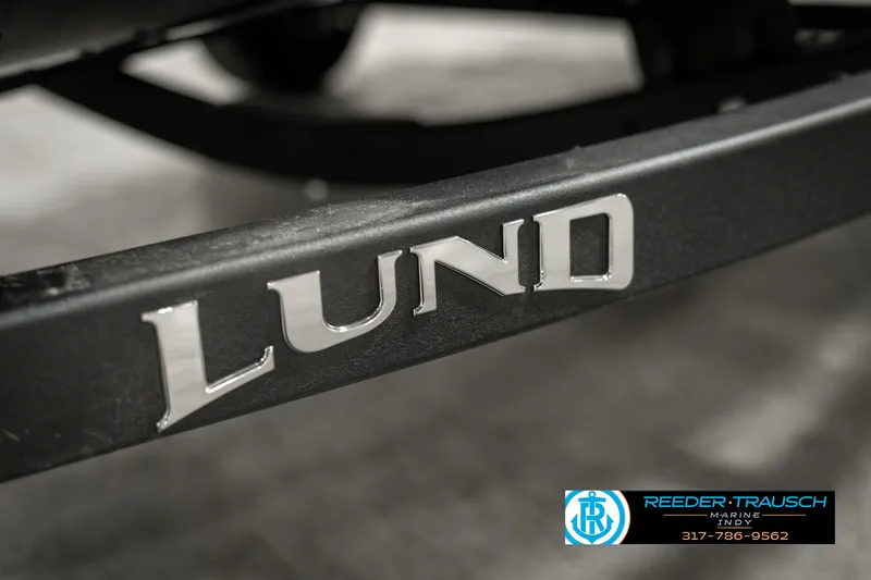 Slide: The Image of 2025 Lund 1675 Adventure SS boat trailer with logo, close-up view. - 41