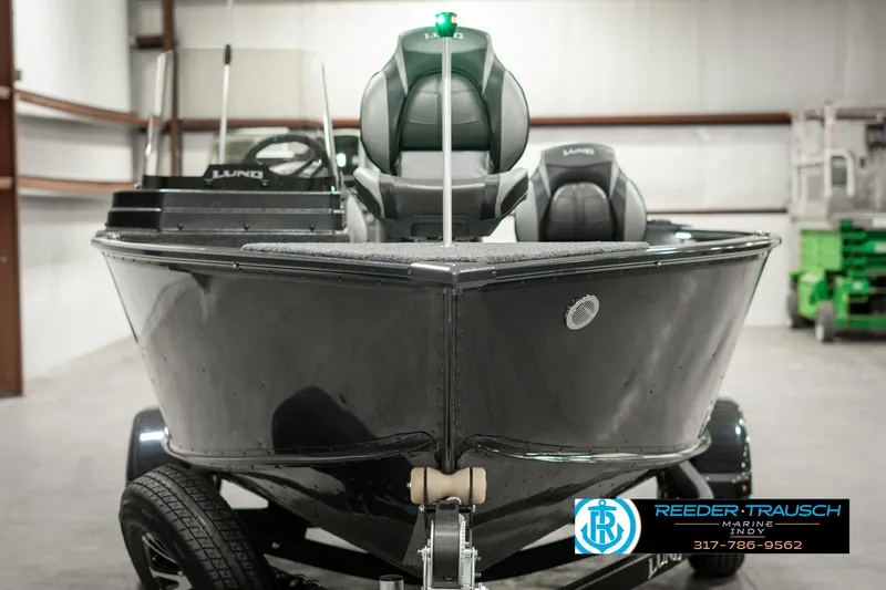 Slide: The Image of 2025 Lund 1675 Adventure SS boat in a showroom, front view, on a trailer. - 6