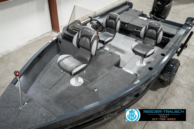 Slide: The Image of 2025 Lund 1675 Adventure SS boat interior with gray seating and carpeted deck. - 7