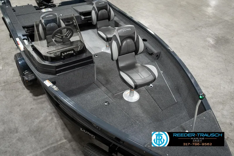 Slide: The Image of 2025 Lund 1675 Adventure SS boat with dual seats and steering console in showroom. - 8