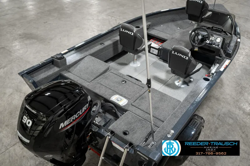 Slide: The Image of 2025 Lund 1675 Adventure SS boat interior with Mercury 90 engine, gray seating, and steering console. - 9