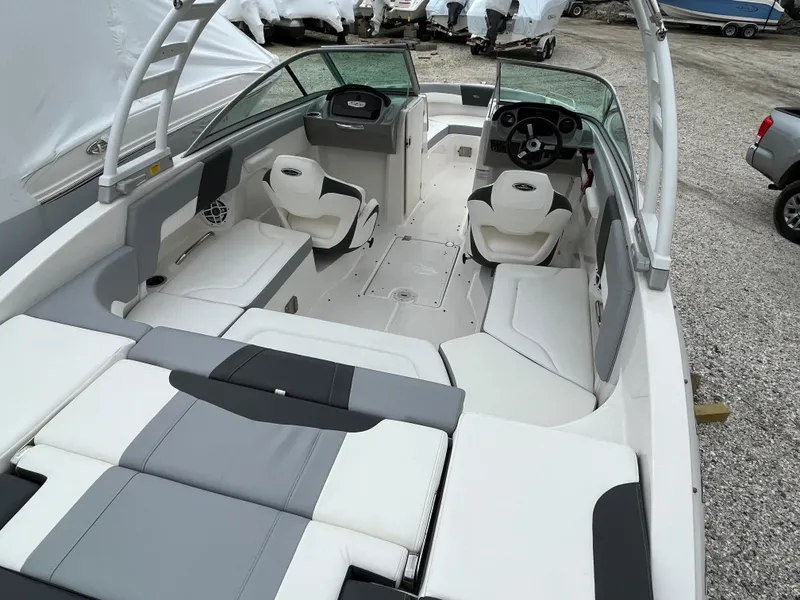 Slide: The Image of 2023 Chaparral 23 SSIOB boat interior with seating and steering wheel. - 11
