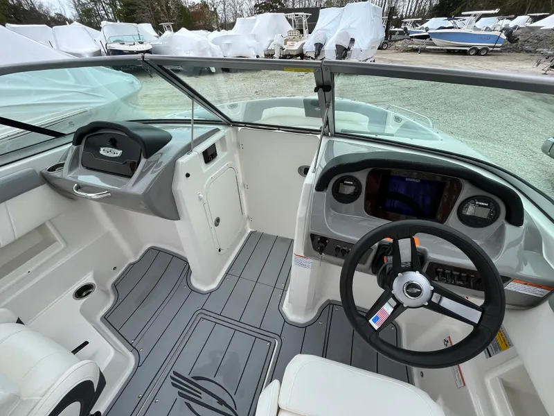 Slide: The Image of 2023 Chaparral 23 SSIOB boat interior with modern dashboard and steering wheel. - 12