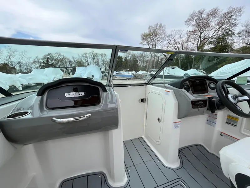 Slide: The Image of 2023 Chaparral 23 SSIOB boat interior with modern dashboard and steering wheel. - 15