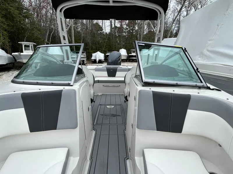 Slide: The Image of 2023 Chaparral 23 SSIOB boat interior with dual windshields and seating. - 19