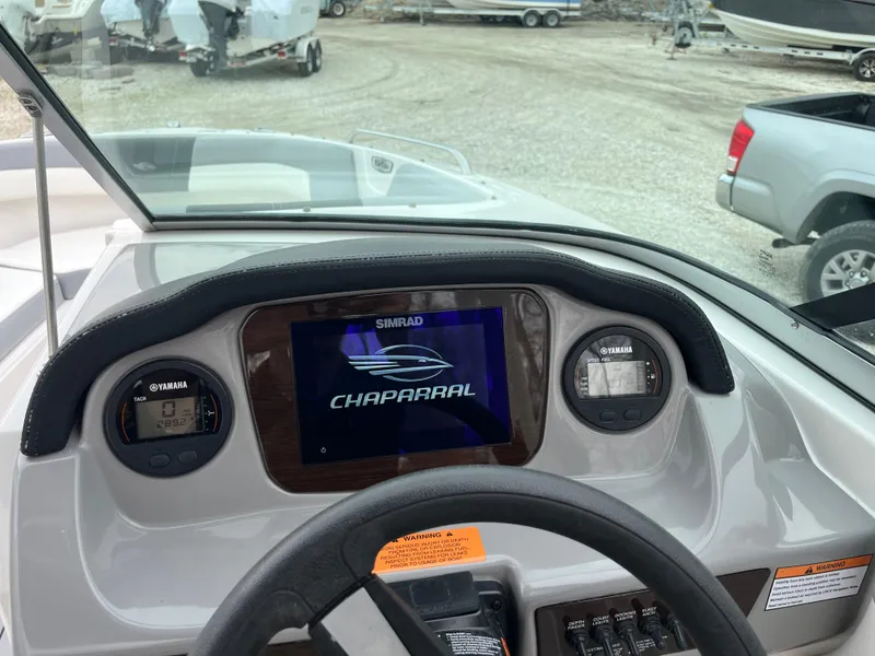 Slide: The Image of 2023 Chaparral 23 SSIOB boat dashboard with Simrad display and Yamaha gauges. - 21