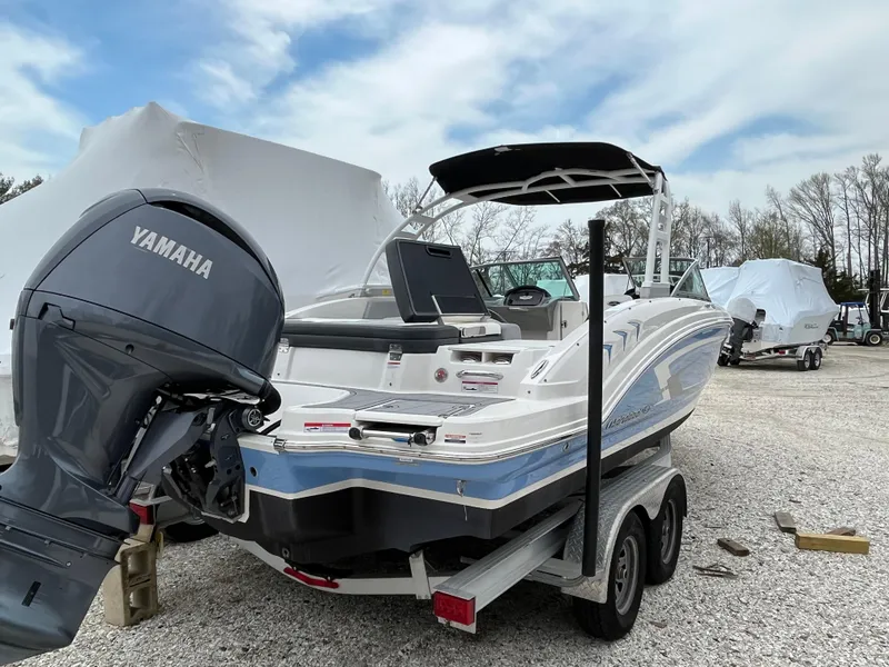 Slide: The Image of 2023 Chaparral 23 SSIOB boat with Yamaha outboard motor on a trailer. - 5