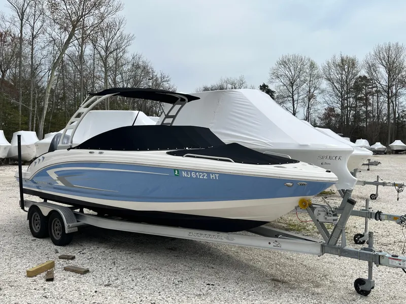 Slide: The Image of 2023 Chaparral 23 SSIOB boat on trailer, parked outdoors. - 7
