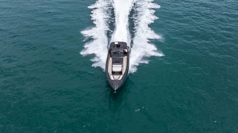 Slide: The Image of 2025 Cigarette 42 Auroris speedboat cruising on open water, aerial view. - 11