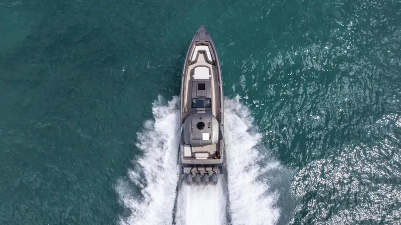 Slide: The Image of Aerial view of 2025 Cigarette 42 Auroris speedboat cruising on turquoise water. - 26