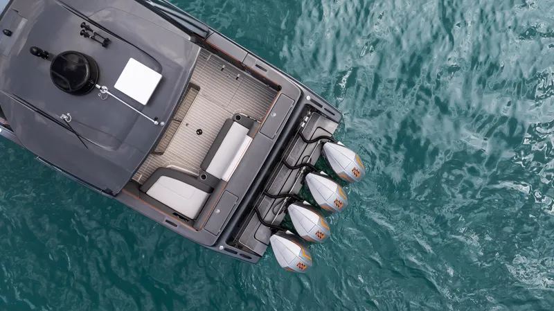 Slide: The Image of Aerial view of 2025 Cigarette 42 Auroris boat with triple outboard engines on blue water. - 29