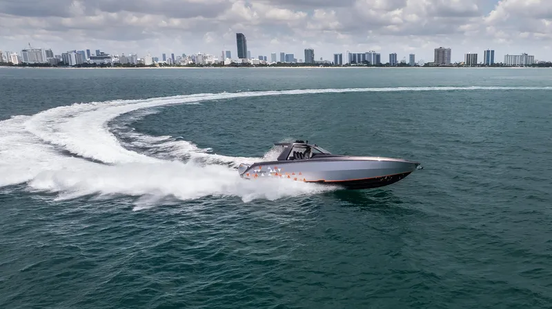 Slide: The Image of 2025 Cigarette 42 Auroris speedboat cruising on open water with city skyline in background. - 3