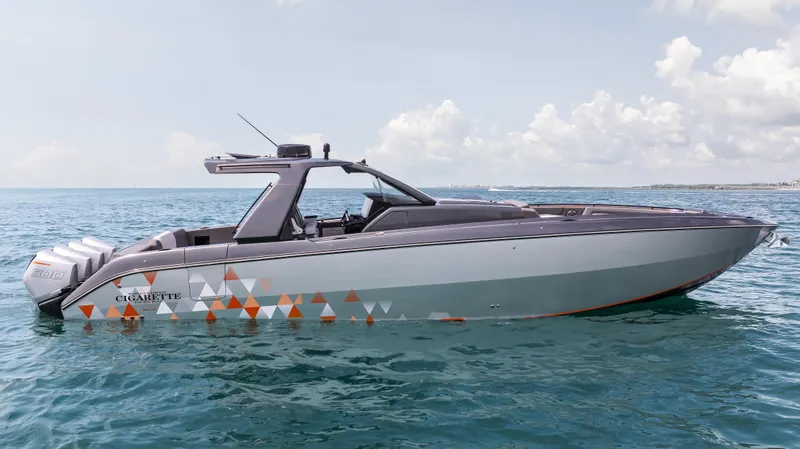 Slide: The Image of 2025 Cigarette 42 Auroris boat on open water under a clear sky. - 4