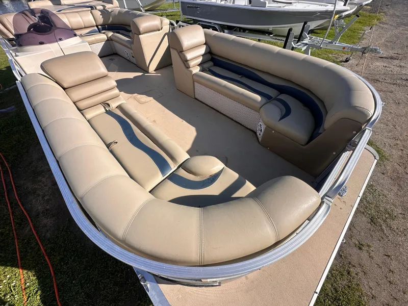 Slide: The Image of 2011 Avalon Windjammer 24' pontoon boat with beige seating and spacious layout. - 10