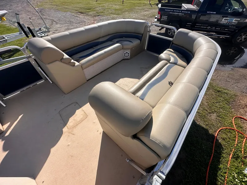 Slide: The Image of 2011 Avalon Windjammer 24' pontoon boat with spacious seating and beige upholstery. - 9