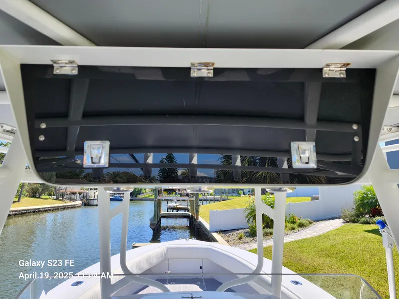 Slide: The Image of 2001 Jupiter 31 Open Center Console boat, docked by a scenic waterfront. - 15