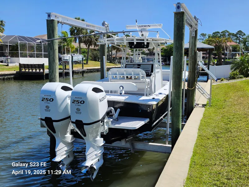 Slide: The Image of 2001 Jupiter 31 Open Center Console boat docked with twin Honda 250 engines. - 17