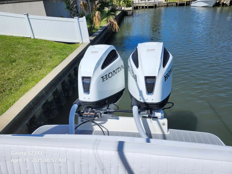Slide: The Image of Twin Honda outboard engines on a 2001 Jupiter 31 Open Center Console boat. - 18