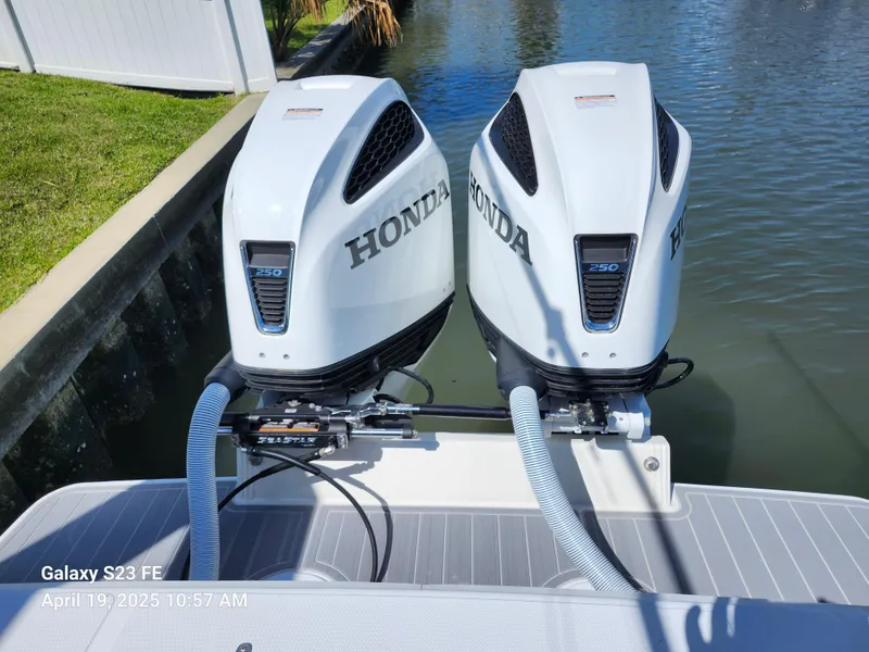 Slide: The Image of Twin Honda outboard motors on a 2001 Jupiter 31 Open Center Console boat. - 19