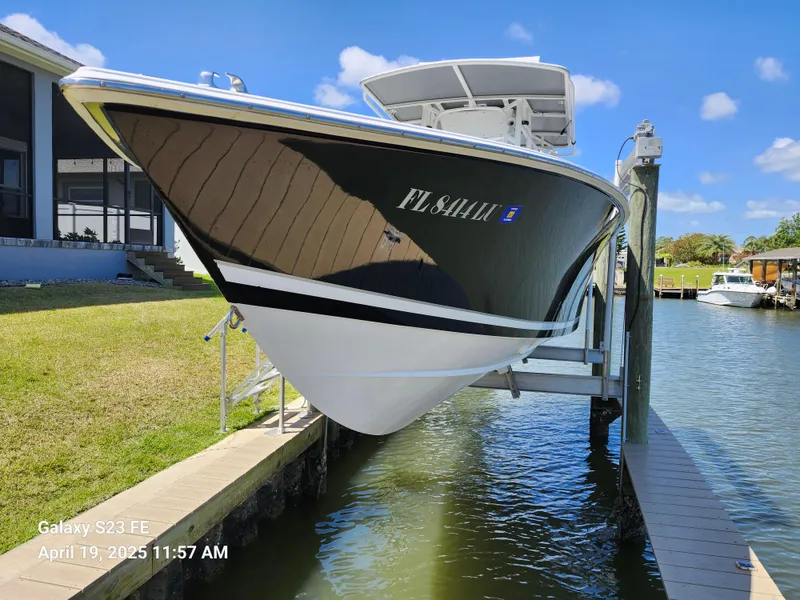 Slide: The Image of 2001 Jupiter 31 Open Center Console boat docked, sunny day, blue sky, waterfront setting. - 2
