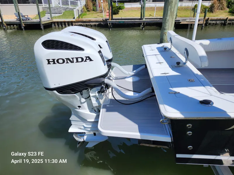 Slide: The Image of 2001 Jupiter 31 Open Center Console with Honda outboard engines docked in marina. - 20