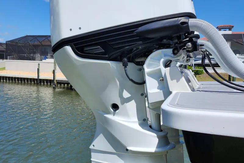 Slide: The Image of Outboard motor of a 2001 Jupiter 31 Open Center Console boat on water. - 21