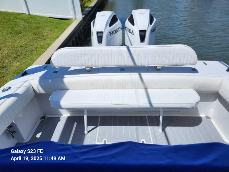 Slide: The Image of 2001 Jupiter 31 Open Center Console with Honda outboard motors, docked by a canal. - 22