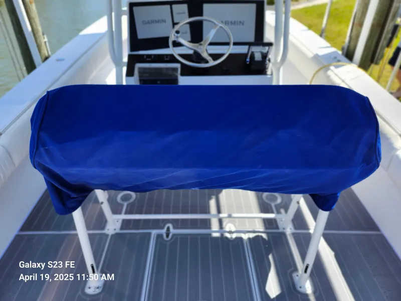 Slide: The Image of 2001 Jupiter 31 Open Center Console boat helm with blue cover and Garmin electronics. - 23