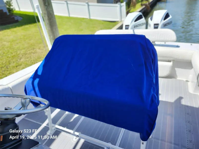 Slide: The Image of 2001 Jupiter 31 Open Center Console boat with blue cover, dual Honda engines. - 24