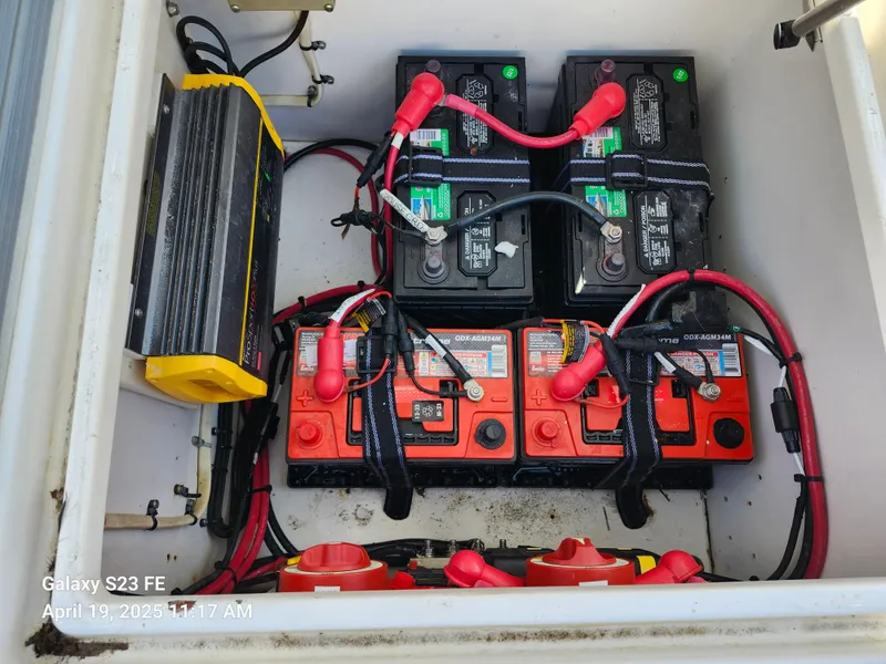 Slide: The Image of Battery compartment of a 2001 Jupiter 31 Open Center Console boat with wiring and charger. - 27