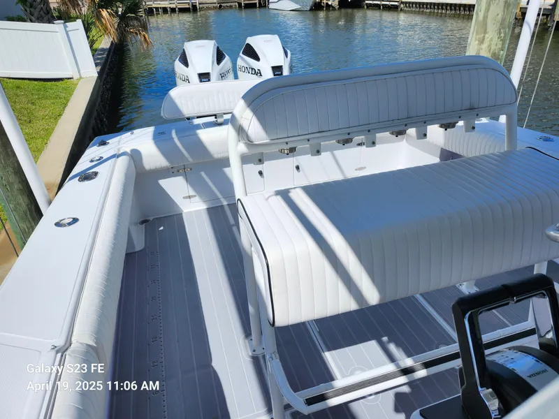 Slide: The Image of 2001 Jupiter 31 Open Center Console boat with Honda engines docked by the water. - 32