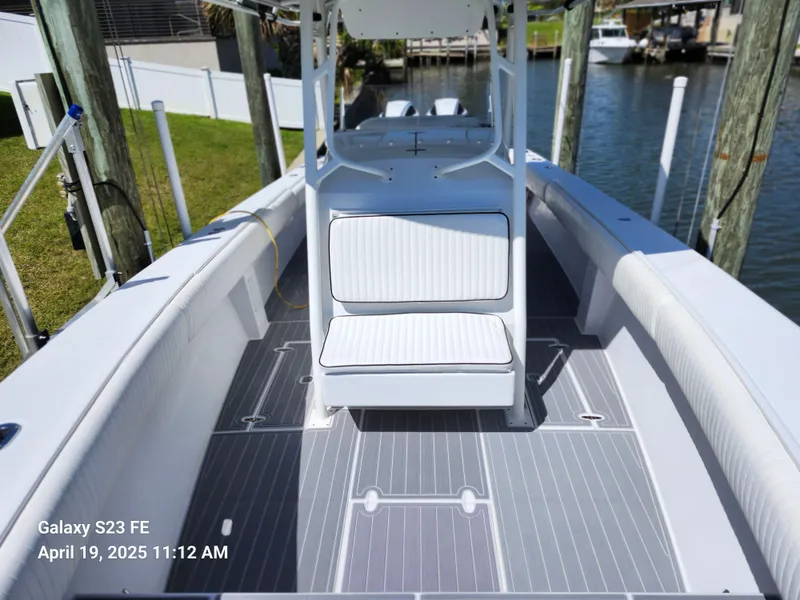Slide: The Image of 2001 Jupiter 31 Open Center Console boat docked by the water. - 33