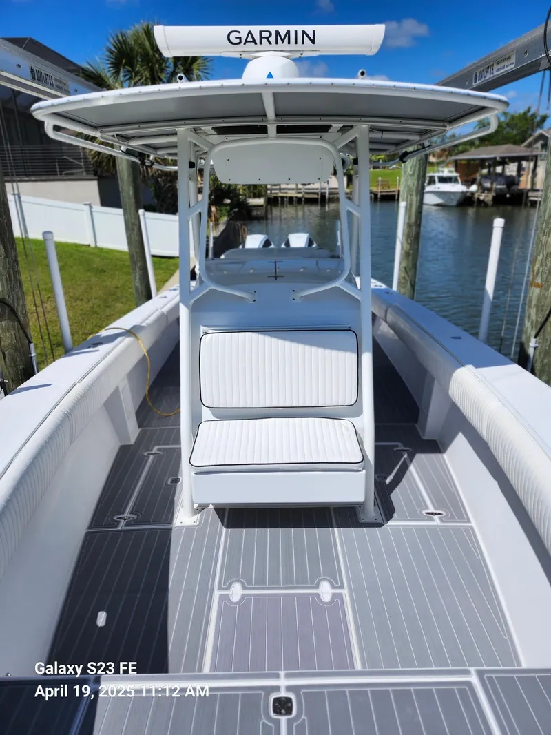 Slide: The Image of 2001 Jupiter 31 Open Center Console boat with Garmin equipment, docked on a sunny day. - 34