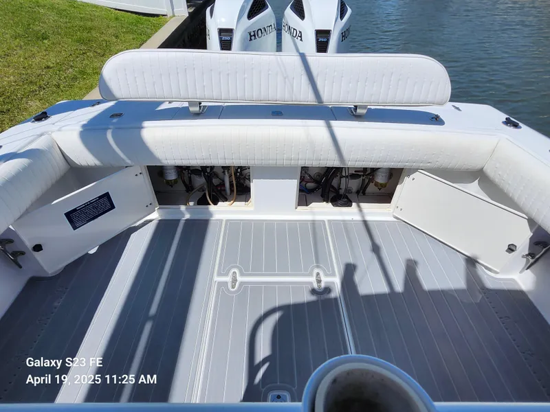 Slide: The Image of 2001 Jupiter 31 Open Center Console boat interior with Honda engines, docked by the water. - 38