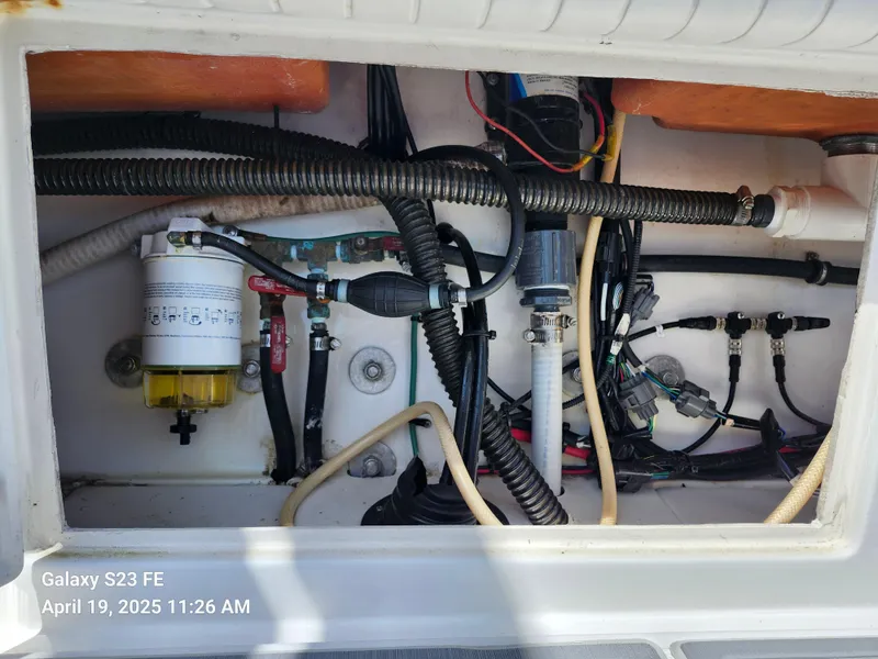 Slide: The Image of Engine compartment of a 2001 Jupiter 31 Open Center Console boat, showing wiring and components. - 39