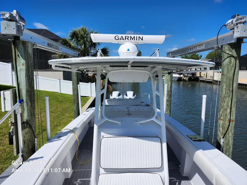 Slide: The Image of 2001 Jupiter 31 Open Center Console boat docked, featuring Garmin equipment, under clear blue skies. - 4