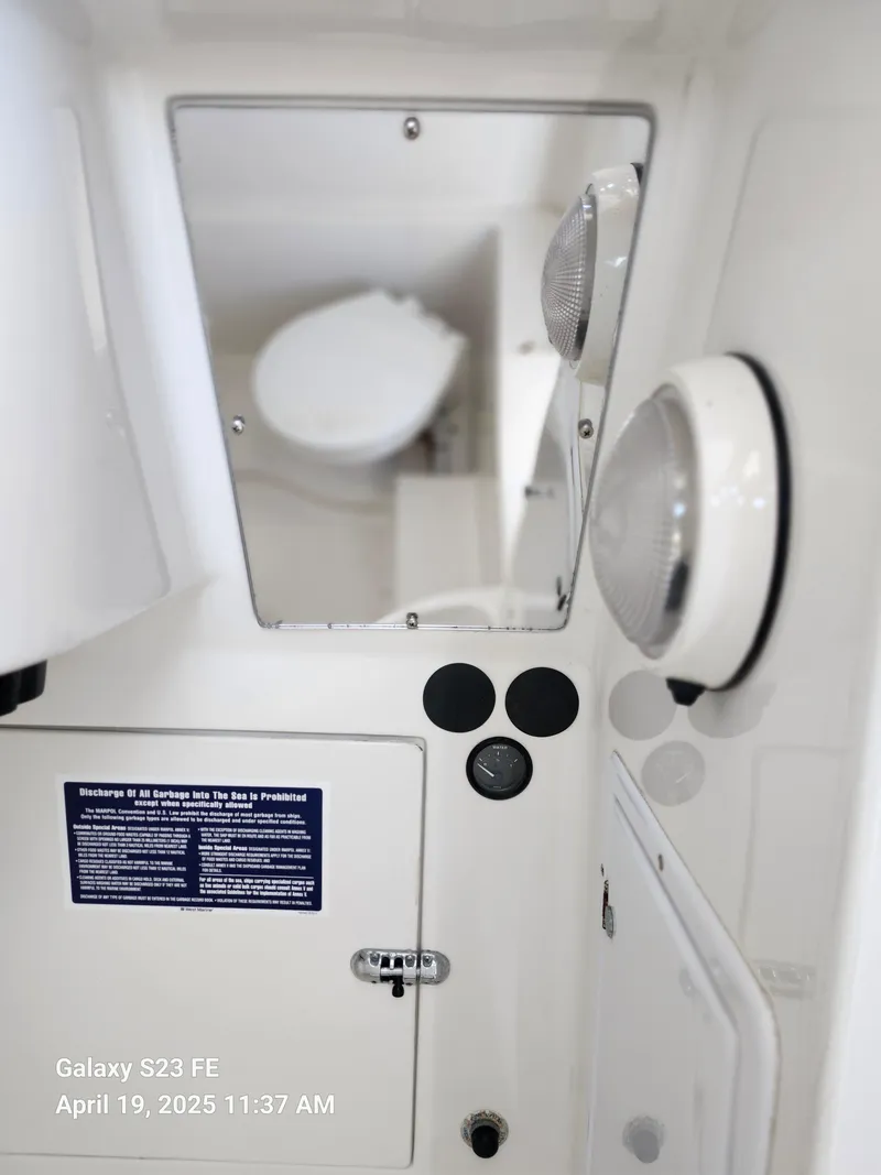 Slide: The Image of Interior view of a 2001 Jupiter 31 Open Center Console boat, featuring a mirror and light fixtures. - 41