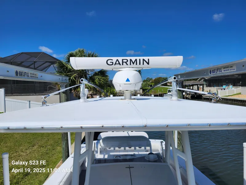 Slide: The Image of Jupiter 31 Open Center Console boat with Garmin radar, docked under clear blue sky. - 5
